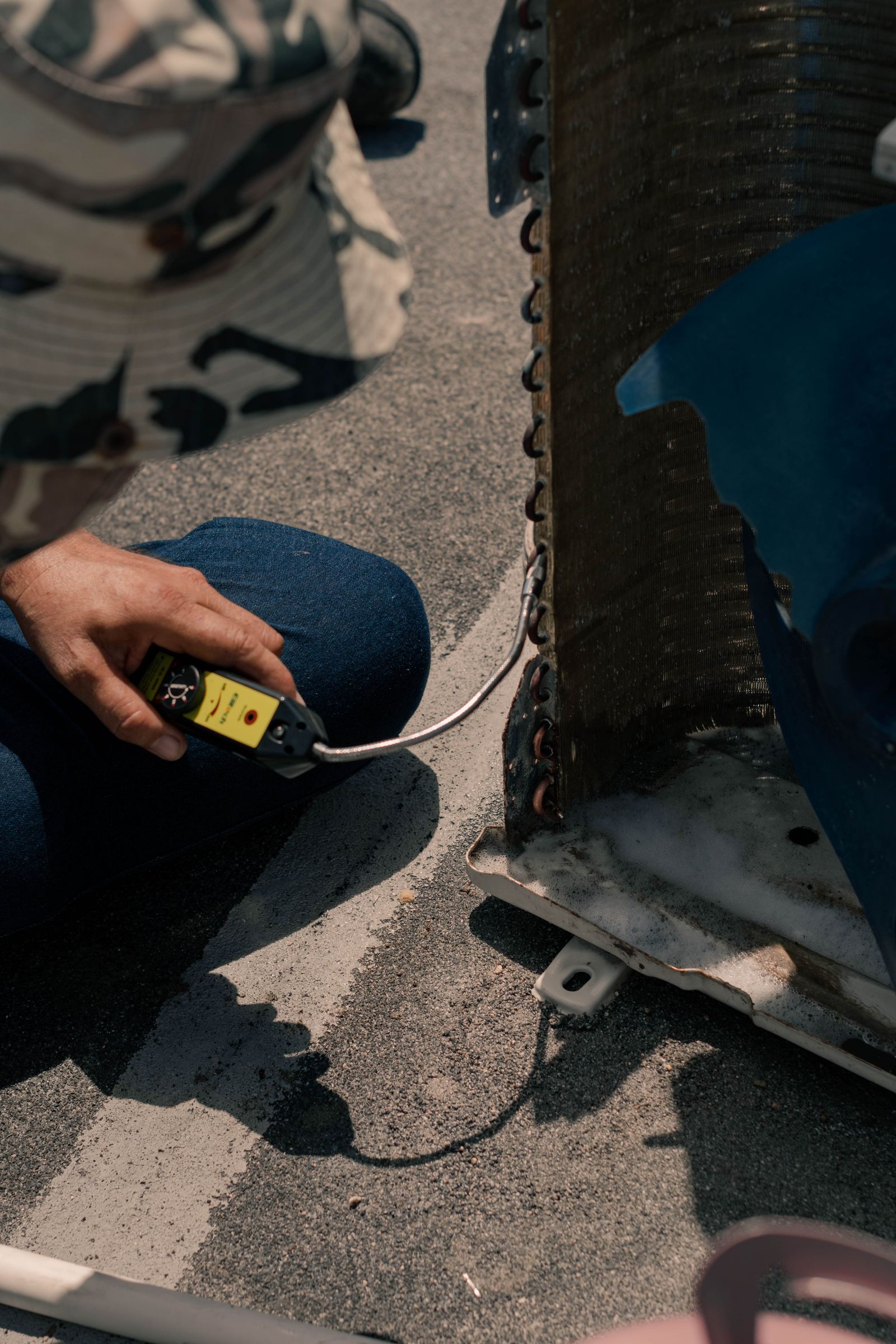 Technician testing an air conditioning unit